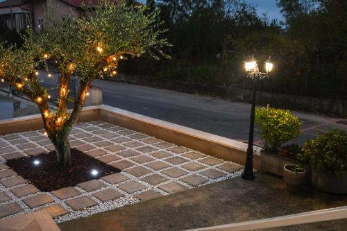 a street light and a tree with lights on it at La Casa Della Nonna in Montemiletto