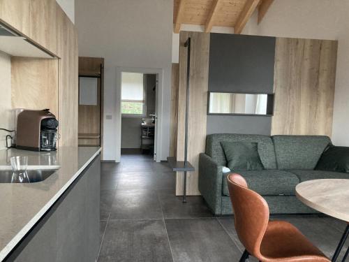 a kitchen and living room with a couch and a table at Maso Valèr - Agritur in Tassullo