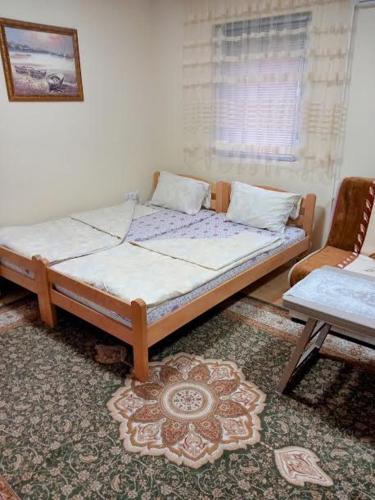 a bed sitting in a room with a window at Apartman Turkana 2 in Sarajevo