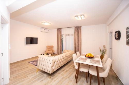 a living room with a couch and a table at Stone Villa with pool Montenegro Star in Kaluđerac