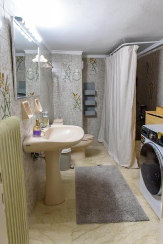 a bathroom with a sink and a toilet and a microwave at Joanna's city centre apartment in Tripoli