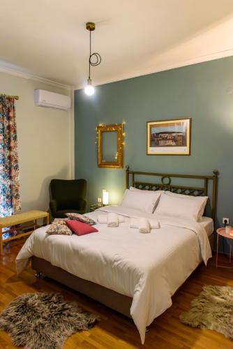 a bedroom with a large bed and a chair at Joanna's city centre apartment in Tripoli