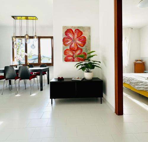 a living room with a dining table and a bedroom at Il Bacio del sole 2 in Maccagno Inferiore