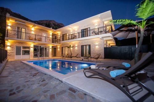 a villa with a swimming pool at night at Stone Villa with pool Montenegro Star in Kaluđerac