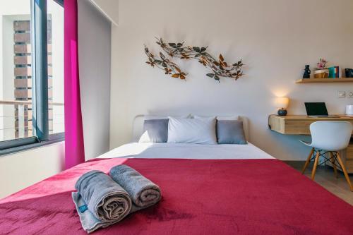 a bedroom with a large bed with a red rug at Luxury Penthouse with Jacuzzi, 2 min to Beach in Mont Choisy