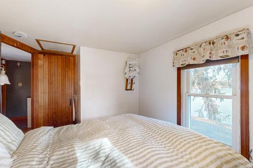a bedroom with a large bed and a window at Lakefront Living in Bomoseen