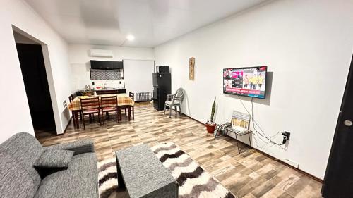 a living room with a couch and a dining room at Casitas Atlántida in Atlántida