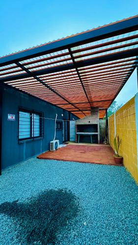 a house with a patio with a wooden ceiling at Casitas Atlántida in Atlántida