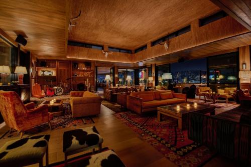 a living room with couches and chairs and a room with at HOLLYWOOD VOLUME, a Tribute Portfolio Hotel in Los Angeles