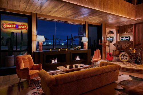 a living room with a couch and a fireplace at HOLLYWOOD VOLUME, a Tribute Portfolio Hotel in Los Angeles