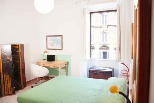 a bedroom with a bed and a desk and a window at Shangrila in Rome