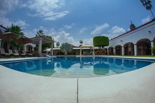 a large swimming pool in the middle of a building at Ex Hacienda Santa Cecilia in Cuernavaca