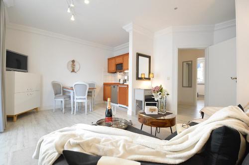 a living room with a couch and a table at Appartement-Villa Steinfurth in Binz