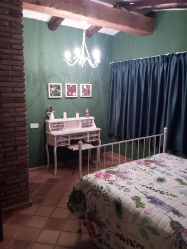 a bedroom with a bed and a desk in it at Mas Valoria in Peratallada