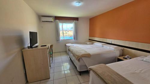 Postel nebo postele na pokoji v ubytování JL Temporadas - Quarto Portobello Park Hotel