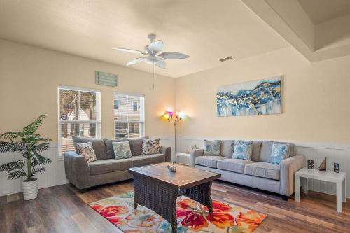 a living room with a couch and a table at Walk to Beach Shared Pool & Grill Dog Friendly in Padre Island