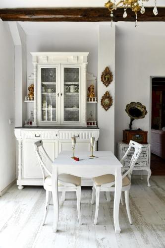 a white dining room with a white table and chairs at Mas Valoria in Peratallada