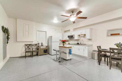 a kitchen with white cabinets and a ceiling fan at 10 Mi to Yosemite Lake Atwater Retreat in Atwater