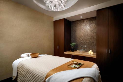 a bedroom with a bed with a tray on it at The Ritz-Carlton, Toronto in Toronto