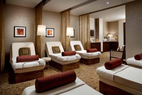 a hotel room with four chairs and a room with at The Ritz-Carlton, Toronto in Toronto