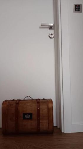a suitcase sitting in front of a door at CASA OURO D'ALVA - Luxury Lodging, SPA & WELLNESS in Penalva do Castelo