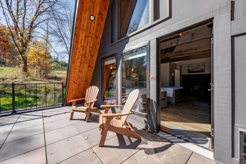 two chairs and a table on a patio at Cove Creek Lodge 211 Standard Double Queen Fireplace Room in Oakland