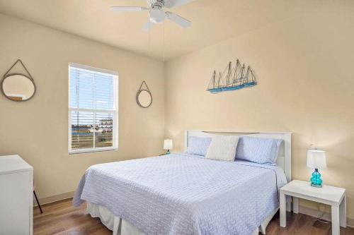 a bedroom with a bed and a ceiling fan at 3 Br Padre Isl Retreat Min to Beach Dog Friendly in Padre Island