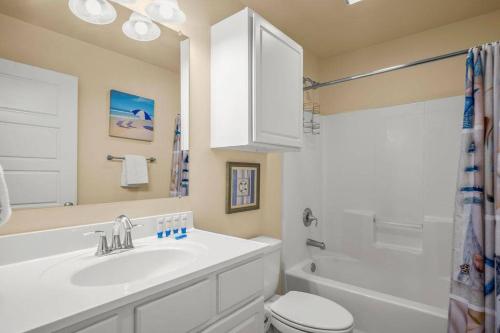 a bathroom with a sink and a toilet and a shower at 3 Br Padre Isl Retreat Min to Beach Dog Friendly in Padre Island