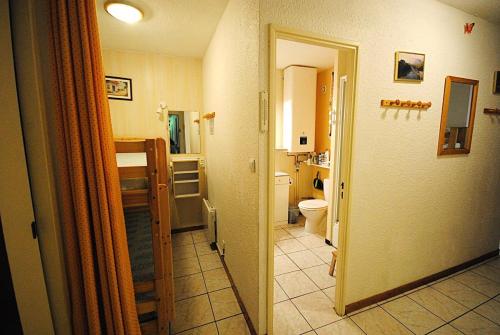 a hallway of a bathroom with a toilet and a sink at Résidence Roches Rousses B - studio box 5/6 personnes MAE-2776 in Orcières