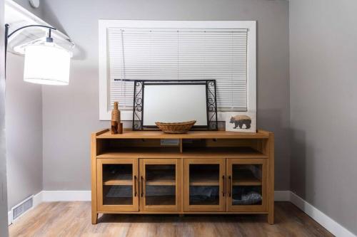 a mirror on top of a wooden cabinet in a room at Cozy 3BR Haven in Hillsdale