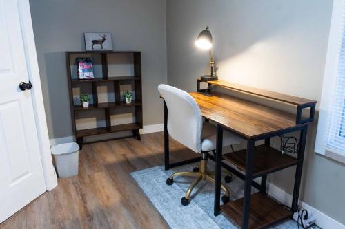 an office with a desk with a chair and a lamp at Cozy 3BR Haven in Hillsdale