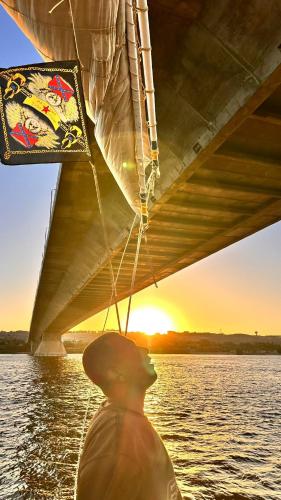 a person on a boat in the water at Mama Africa Felucca in Aswan