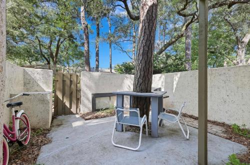 a table and two chairs sitting next to a tree at #81 Beautiful Large 2 Assigned Parking Pool Pet Friendly Near All in Hilton Head Island