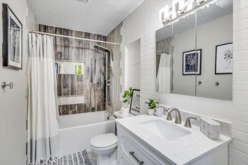 a white bathroom with a sink and a toilet at Andover Bungalow - Sleeps 6 in Andover