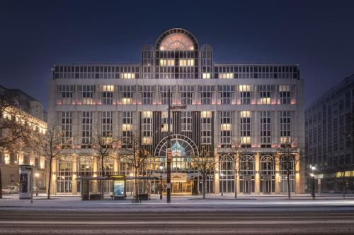 a large building with a clock on it at night at Vienna Marriott Hotel in Vienna