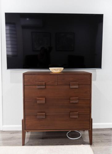 a dresser with a television on top of it at 50 M to Sand LGB 2 King Suites in Long Beach