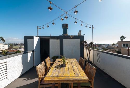 a wooden table on the roof of a house at 50 M to Sand LGB 2 King Suites in Long Beach