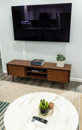 a living room with a tv and a coffee table at 50 M to Sand LGB 2 King Suites in Long Beach