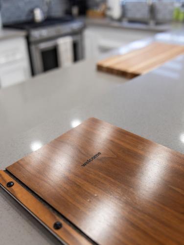 a wooden cutting board on a counter in a kitchen at 50 M to Sand LGB 2 King Suites in Long Beach