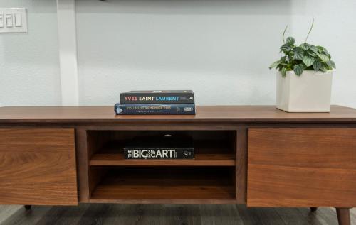 a desk with two books and a potted plant at 50 M to Sand LGB 2 King Suites in Long Beach