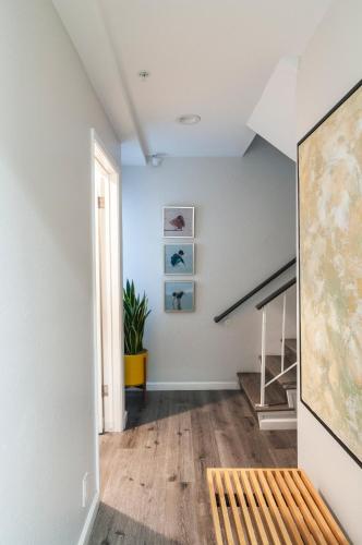a hallway with a bench and stairs in a house at 50 M to Sand LGB 2 King Suites in Long Beach