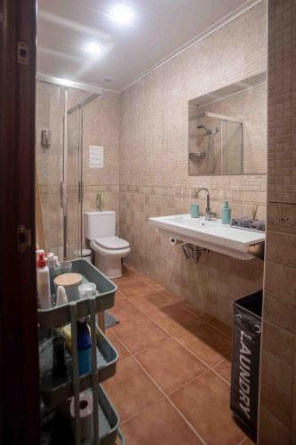 a bathroom with a sink and a toilet at Gurtxu Rooms by Sun Sebastián in San Sebastián