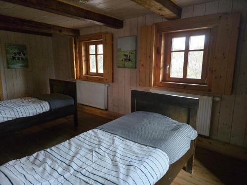 Ένα ή περισσότερα κρεβάτια σε δωμάτιο στο Hygge Młyńsko