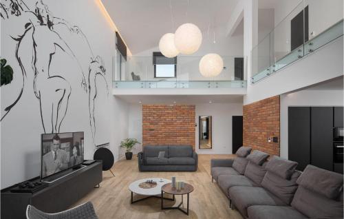 a living room with a couch and a tv at Villa Eden in Ližnjan