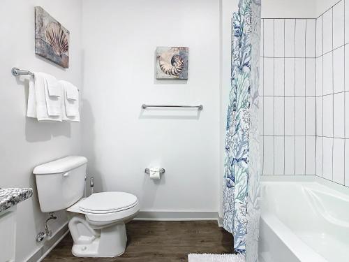 a bathroom with a toilet and a shower curtain at Luxury Apartments Near Disney in Orlando