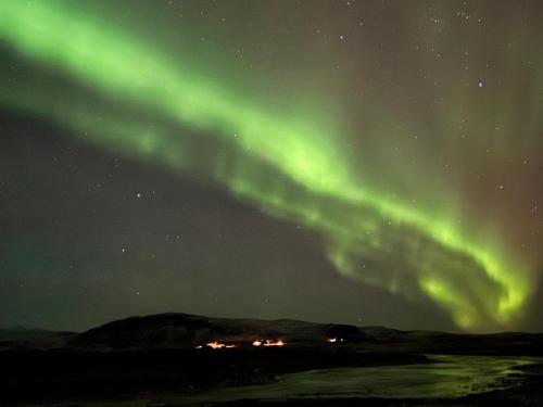 an image of the northern lights in the sky at Álftártunga Farm Guesthouse in Borgarnes