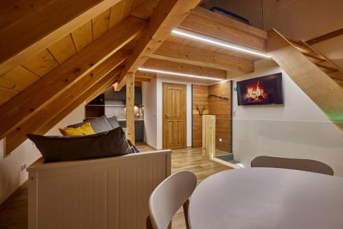 a room with a white table and chairs and wooden ceilings at Urlas Apartments, dog friendly, shortcut to Sněžka Mountain in Pec pod Sněžkou