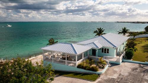 an aerial view of a house on the water at Private Oceanfront, beach, dock and Hottub - The Perky Pelican in Marsh Harbour