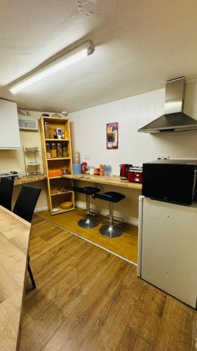 a kitchen with a counter and a table in it at White House Lodge in Cambridge