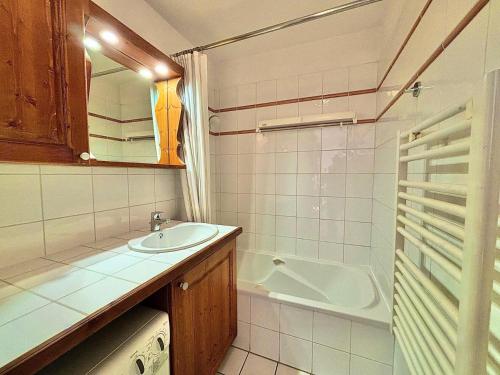 La petite salle de bains est pourvue d'un lavabo et d'une baignoire. dans l'établissement Résidence Les Alpages De Reberty - Alpages de Reberty - Ancolie 11 MAE-5384, aux Menuires